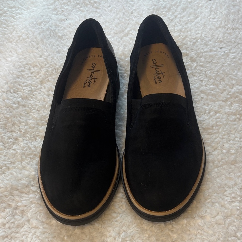 Clark’s Womens size 6 black suede slip/on shoes. No wear. The heel is 1 1/2 in.